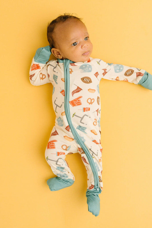 Touchdown Time bamboo sleeper - close-up of football, helmet and foam finger print with teal two-way zipper